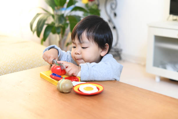 istock Image of a boy playing house with toys 2036857760