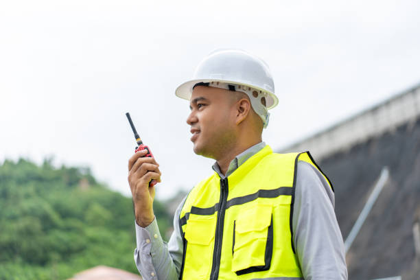 istock Professional asian maintenance engineer man with safety helmet in construction site dam with hydroelectric power plant and irrigation. Manager engineer man working at project big building. 2036860716