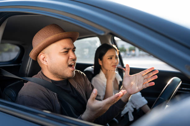 young asian couple man and woman quarrel in car angry face. relationships problems conflicts in marriage. driving during rush hour  traffic feeling serious and stressed argument fighting shouting - accident taxi driving tourist - fotografias e filmes do acervo