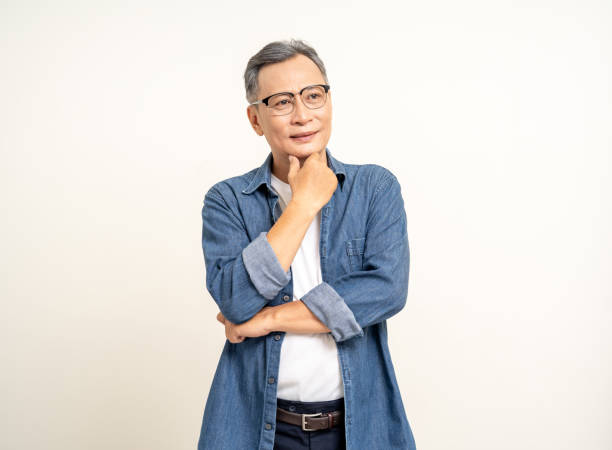 istock Handsome asian mature old man standing pose thinking on isolated white background. Happy Portrait of cheerful smiling senior asian man looking at camera. Mature People and lifestyle 2036868442