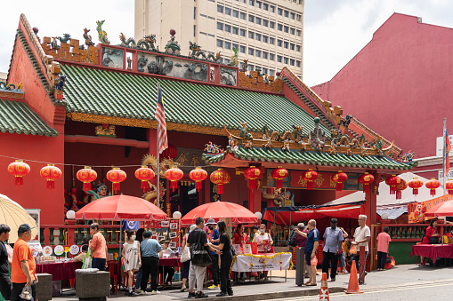KL, Malaysia - February 4,2024 : Various types of sourvenir stalls in front of the Guan Di Temple in Chinatown nearby Petaling Street during Chinese New Year. People can seen exploring around it.