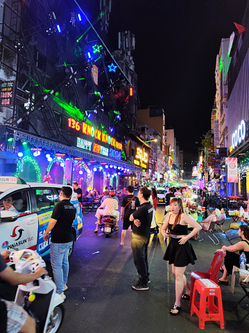 Crowd of people walking in Bui Vien Street, the main nightlife street of Pham Ngu Lao, the so called ‘backpackers area’ of Ho Chi Minh City, Vietnam