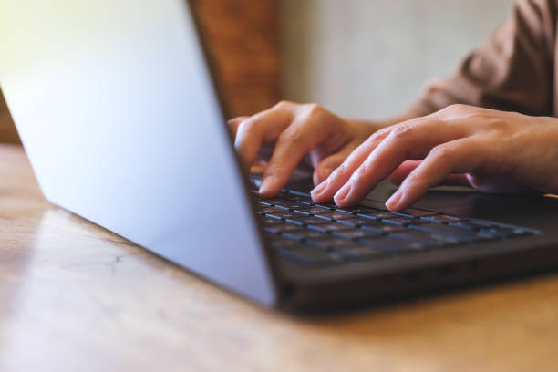 istock Closeup image of hands working and typing on laptop computer keyboard 2036893256
