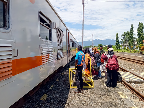 Tegal, central java, indonesia - february 18 2024. Crowd of people of train passenger waiting to enter the train