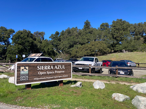 Sierra Azul Open Space Preserve welcome sign at full parking lot - San Jose, California, USA - February 13, 2024