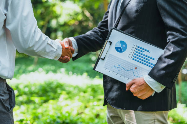 istock World Environment Day business partner colleagues shaking hands during a meeting working together in sustainability. Save Earth, World Environment Day concept, Earth Day. 2036941312