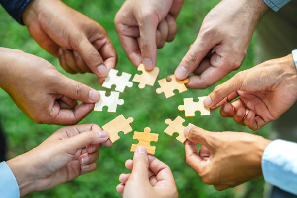 istock World environment day and ESG Concept of teamwork and partnership Hands join Jigsaw puzzle pieces with global community sustainable Save Earth. the Environment World Earth Day concept 2036941817