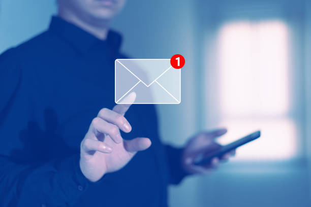 businessman press email screen for responding mail alert sign with blur holding smartphone