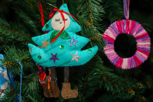 istock A homemade rag Christmas tree on the branches of a pine tree. 2036991749