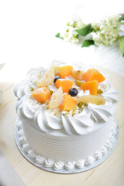 istock freshly handmade beautiful wedding birthday ice cream cake vanilla mouse peach fruit on white marble luxury background with wood plate flower decoration halal food dessert menu for cafe 2037006421