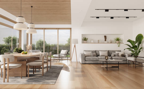 istock Open space living room and kitchen interior with large windows, gray sofa, dining table and hardwood flooring. Modern design solution 2037012326