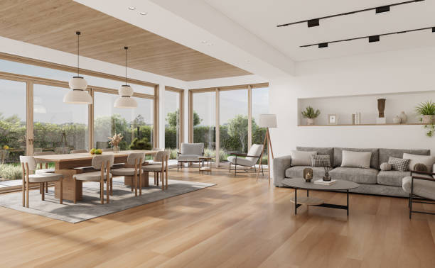 istock Open space living room and kitchen interior with large windows, gray sofa, dining table and hardwood flooring. Modern design solution 2037012328