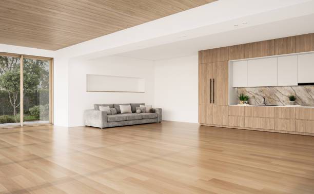 istock Open space living room and kitchen interior with large windows, gray sofa, dining table and hardwood flooring. Modern design solution 2037012345