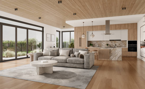 Open space living room and kitchen interior with large windows, gray sofa, dining table and hardwood flooring. Modern design solution