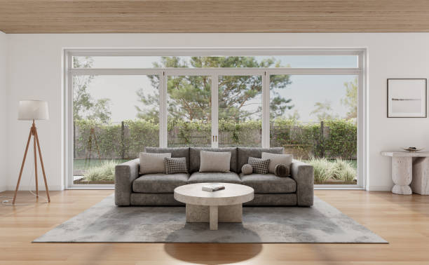istock Open space living room and kitchen interior with large windows, gray sofa, dining table and hardwood flooring. Modern design solution 2037012863