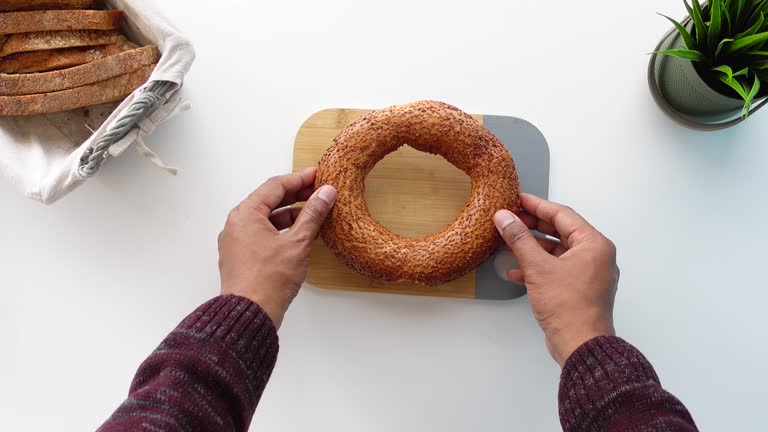 top vie of hand pick Turkish Bagel Simit on table