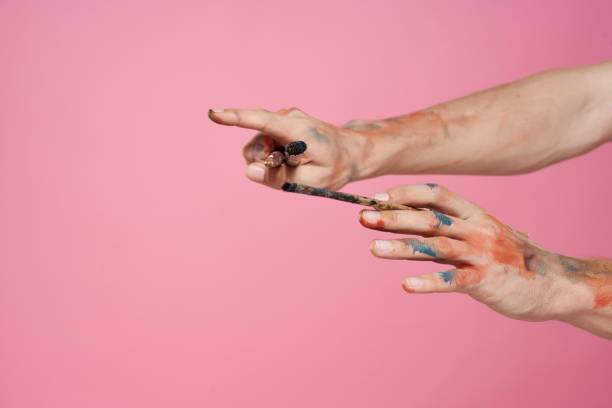 istock Man with brushes in hands paint pink background hobby Creative approach 2037043677
