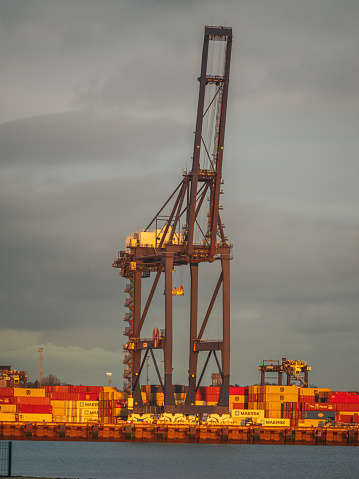 Shotley Gate, Suffolk, England, UK - November 22, 2022: View of the container bridge in Felixstowe harbour with containers in the background