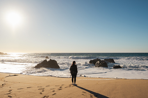 Woman walking on the beach in California