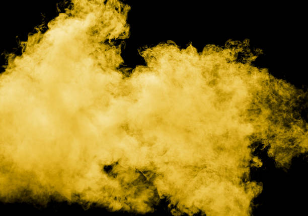 istock Yellow smoke isolated black background 2037071535