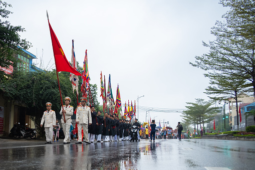 Bac Ninh, Vietnam 02,25,2024 Lim Festival The group of people carrying the flag leads the way