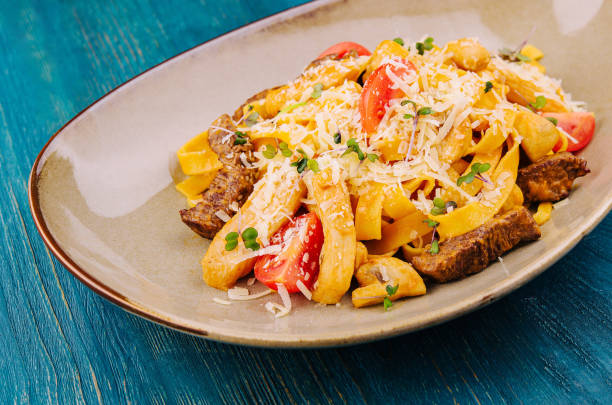 istock Fettuccine pasta with beef, chicken and parmesan 2037136771
