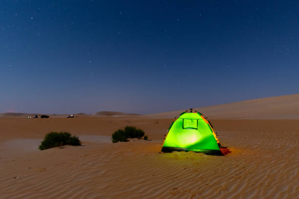 istock night sky over the camping tent during off road in desert. 2037138825