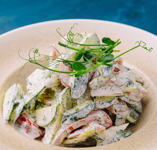 istock Salad with fresh vegetables and cream sause on plate 2037138848