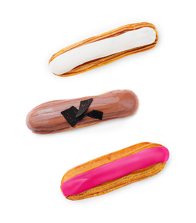 three different eclairs on a white plate isolated on white background