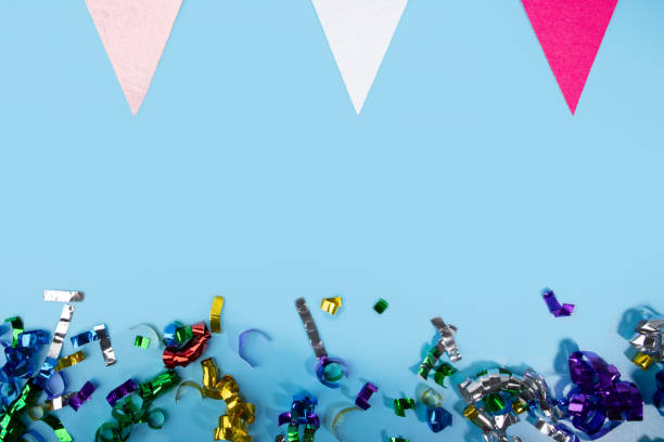 istock Anniversary confetti and holiday flags on blue background, celebratory decorations, festive pennants 2037156580