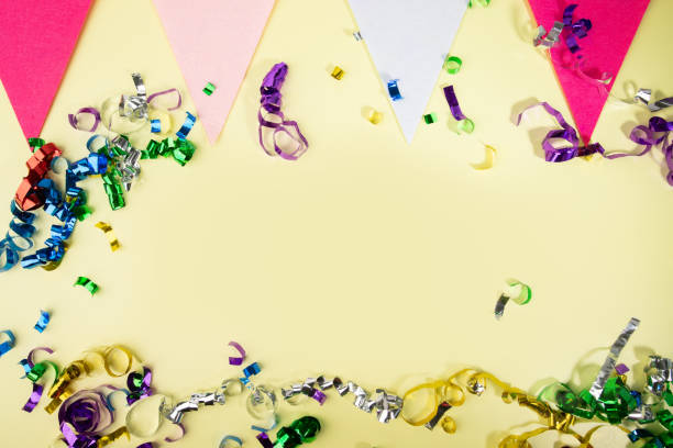istock Yellow background with confetti and holiday flags, celebratory setting, festive decoration, party ambiance 2037156587