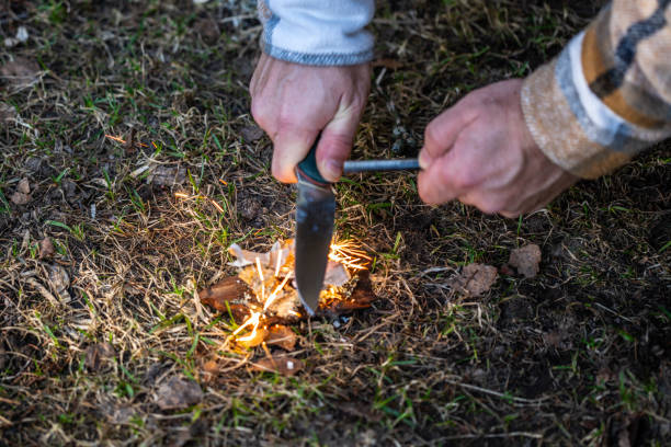 istock A man igniting a campfire in the woods using a survival tool ferrocerium flint lighter fire starter magnesium rod and touristic knife 2037158248