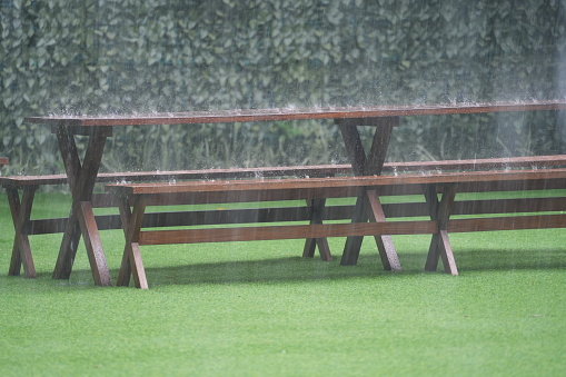 wooden chairs in the yard exposed to rain