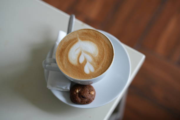 A cup of latte coffee on a cafe table