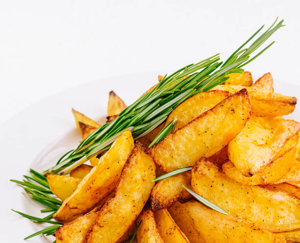 istock Baked potato wedges with rosemary on plate 2037177194