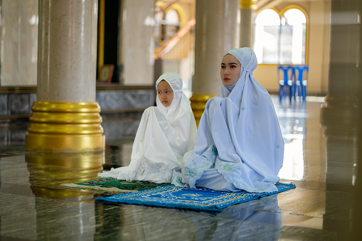 Muslim family using mobile at home during ramadhan