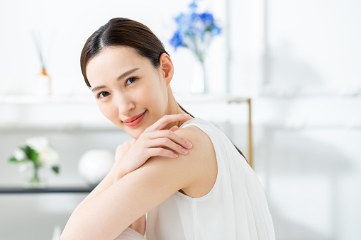 Young Japanese woman satisfied with skin care