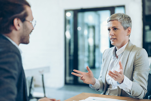 Business persons sitting at a table and talking