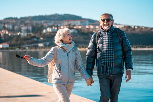 istock Caucasian Senior Couple Enjoying a Walk by the Seaside 2037211708