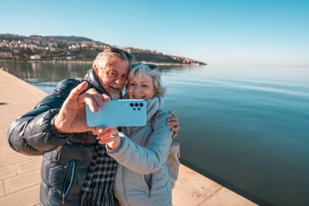 istock Caucasian Senior Couple Taking Selfie at Seaside 2037211712