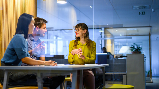 Businessman and businesswomen discussing while sitting in office.