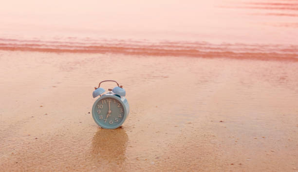 istock Concept alarm clock on beach in summer  island scene 2037242017