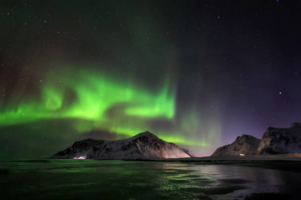 istock Aurora borealis or Northern light rising over Hustind mountain peak with reflection on Skagsanden sand beach 2037245169
