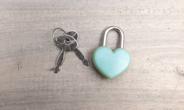 istock A blue love-shaped padlock and a key on a gray table. Blank space for writing. 2037259724