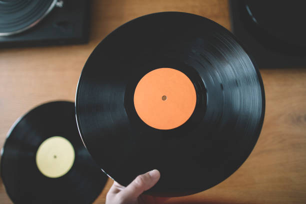 istock Hand holding long play vinyl record 2037265899