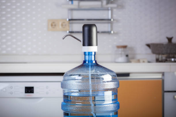 Woman filling water from a water dispenser.