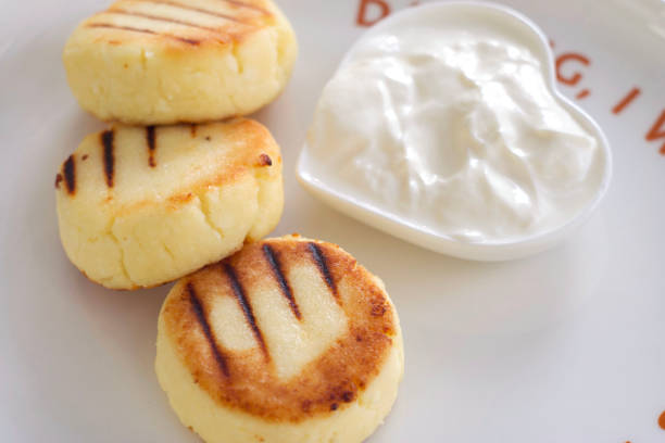 Curd pancakes in a plate on a table in a cafe