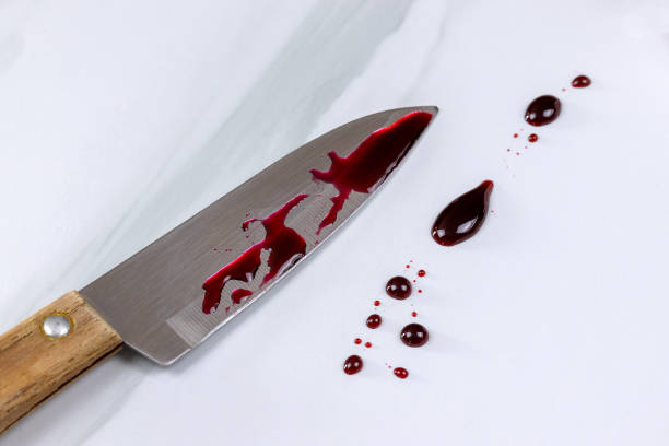 istock bloody knife and blood stains on a table 2037303287