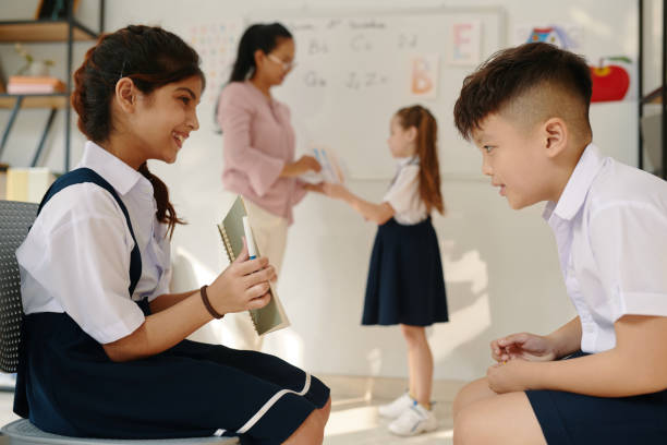 istock Schoolgirl Showing Drawing to Classmate 2037411777