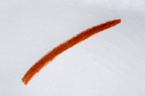 Hand drawn brown crayon or pencil stroke on white paper. Clipping path.